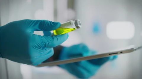 Procedure. A surgeon in a white coat slowly works with a touchscreen tablet Stock Footage 262276173