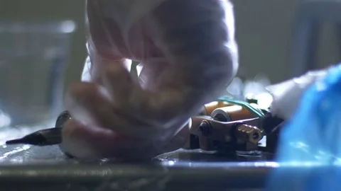 The procedure takes place in the office using a tatoo machine. Stock Footage 70477147