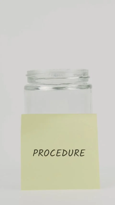 Procedure text or word on yellow sticky note attached to glass jar with hand Video stock 311770645