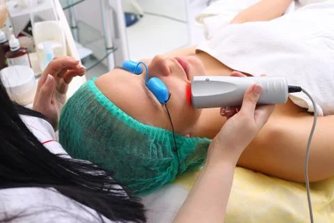The procedure for treating cold laser. Stock Photos