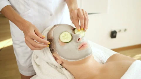 Procedures for patients in the spa. Applying a mask on the face and cucumber Stock Footage 139388238