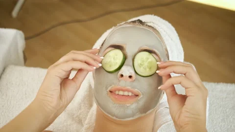 Procedures for patients in the spa. Applying a mask on the face and cucumber Stock Footage 140755532