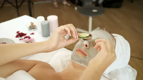 Procedures for patients in the spa. Applying a mask on the face and cucumber Stock Footage 140926594