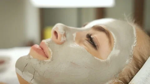Procedures for patients in the spa. Applying a mask on the face and cucumber Stock Footage 144003326