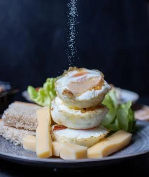 Process of adding salt to the egg breakfast 스톡 사진