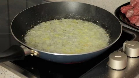 Process of addition of grated carrots in a frying pan where is fried onions Stock-Footage 74675477