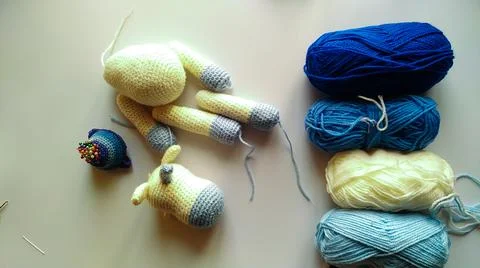Process and materials for crocheting handmade unicorn toy Stock Photos