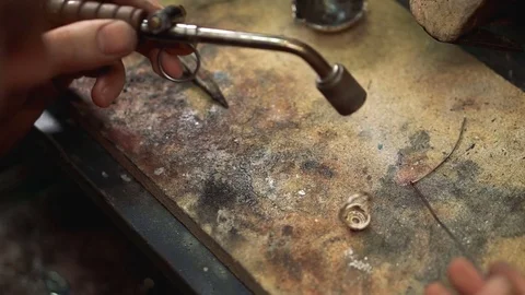 Process annealing using a soldering iron in his hand close up Stock Footage 73461827