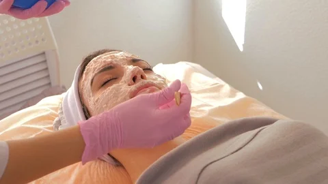 The process of applying alginate mask on the woman's face Stock Footage 118920834