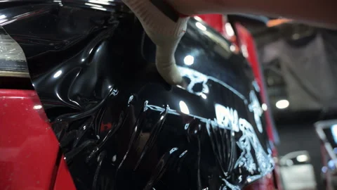 Process of applying a dark PPF film to a truck front side. Close up footage Stock-Footage 294963688