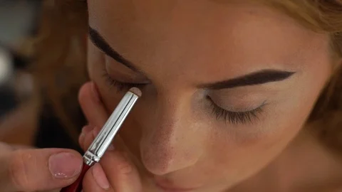 Process applying eyeshadows while elegant eye in beauty studio. Close up Stock Footage 91474595
