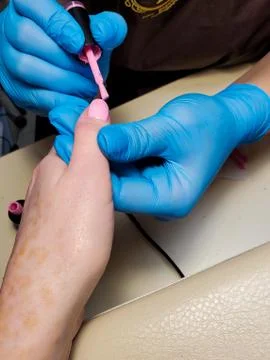 Process of applying gel Polish to nails in a beauty salon close-up Stock Photos