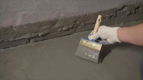 The process of applying mortar - waterproofing to a concrete floor. The conce Stock Photos