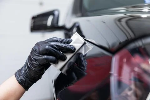 The process of applying a nano-ceramic coating on the car's fender by a male  Stock Photos
