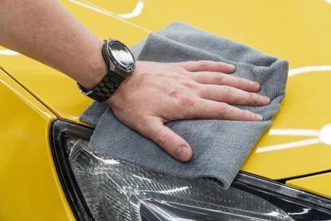 Process of applying a nano-ceramic coating on the yellow car. Stock Photos