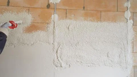 The process of applying plaster using a plastering station. Stock Photos