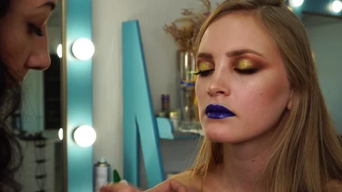 The process of applying set of fake eyelashes on young model wearing shiny Stock Footage 100143044