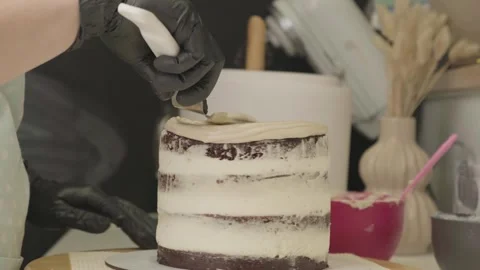 The process of assembling and decorating a cake by confectioner Stock Footage 297777988