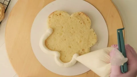 The process of assembling and decorating a cake by confectioner Stock Footage 303970812