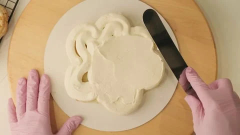 The process of assembling and decorating a cake by confectioner Stock Footage 303970817