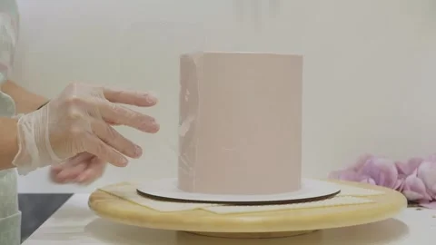 The process of assembling and decorating a cake by confectioner Stock Footage 316260574