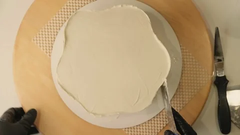 The process of assembling and decorating a cake by confectioner Stock Footage 320131995