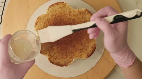 The process of assembling and decorating a cake by confectioner Stock Footage 320132016