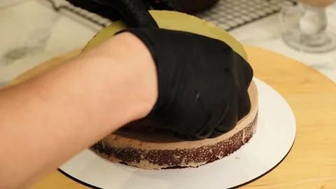 The process of assembling and decorating a cake by confectioner Stock Footage 334962845