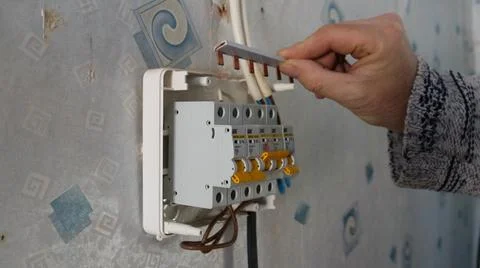 The process of assembling the distribution board and connecting the circuit brea 스톡 사진