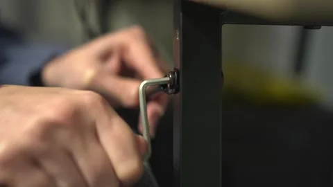 The process of assembling furniture using an Allen wrench requires careful Stock Footage 318544667