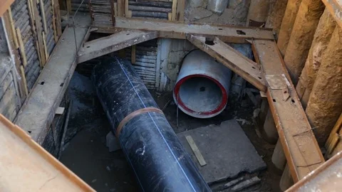 The process of assembling large plastic sewer pipes PEX on the construction site Stock Footage 81917302