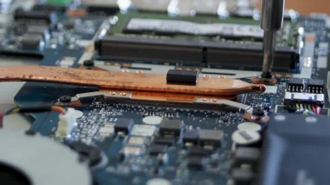 The process of attaching the cooling system to the laptop processor. Screwdriver Stock Footage 297071688