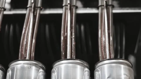 The process of automatically filling metal cans with a drink. Stock Footage 284496673
