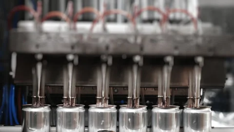 The process of automatically filling metal cans with a drink. Stock Footage 284496745