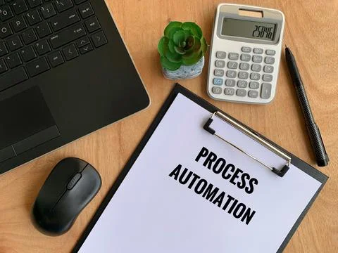 Process automation text written on paper with laptop, pen, calculator, mouse and Stock Photos