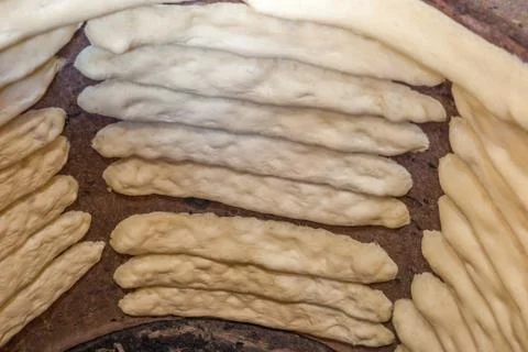 The process of baking bread in a traditional Georgian stove - tone (tandoor) Stock Photos