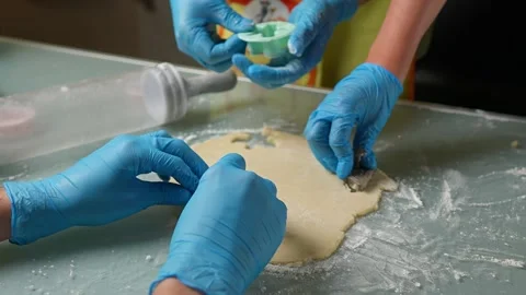 The process of baking by cutting out colourful biscuits with your close friends Stock Footage 295763274