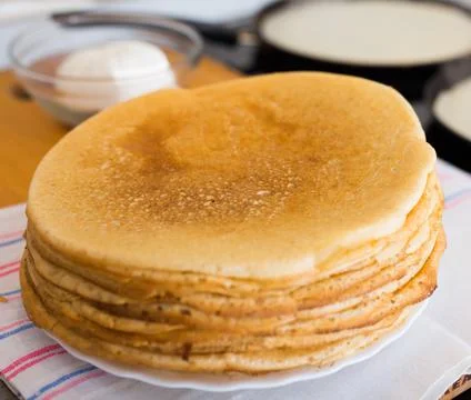 Process of baking pancakes in pans on kitchen stove. stack of hot pancakes Stock-Fotos