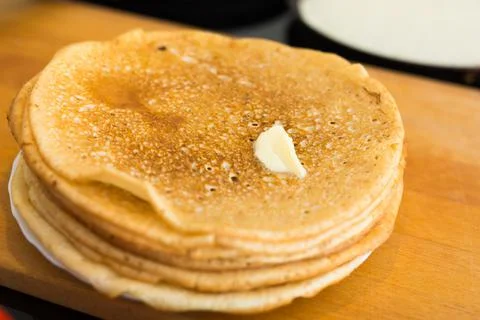Process of baking pancakes in pans on kitchen stove. stack of hot pancakes Stock Photos