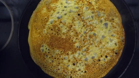 Process of baking thin pancakes on a hot frying pan. Stock Footage 258089339