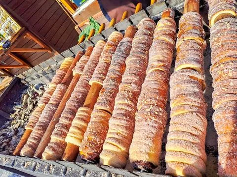 Process of baking trdelnik in Prague, Grilled rolled dough topped with sugar Stock Photos