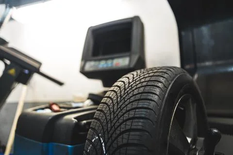 Process of balancing the wheel at the auto repair shop, mechanic concept Stock Photos