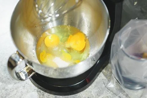 Process of beating eggs in a mixer: making homemade dough for baking. Foto stock