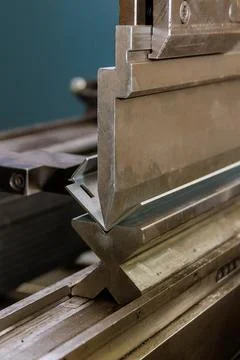 This is the process of bending sheet metal with the help of a hydraulic machine Stock Photos