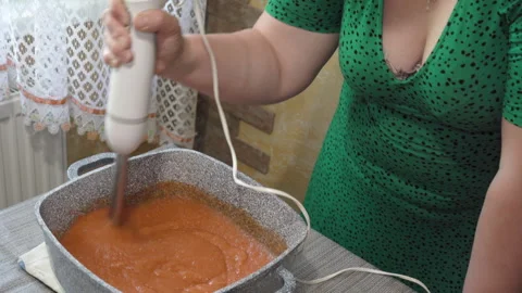 Process of blending hot sauce in a granite pot on the table Vidéo 340404063