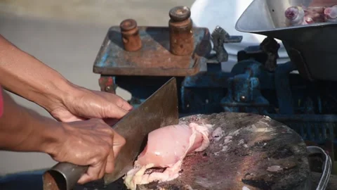 The process of the boiler/chicken being cut by traditional seller Stock Footage 236551193