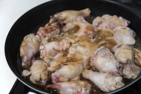 The process of boiling chicken drumsticks Stock Photos