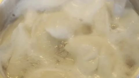 The process of boiling dumplings in water and stirring them with a spoon Stock Footage 155678756