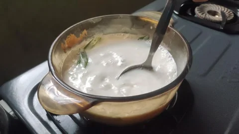 The Process of Boiling Evaporated Milk with Pandan Leaves Vídeo Stock 329397823