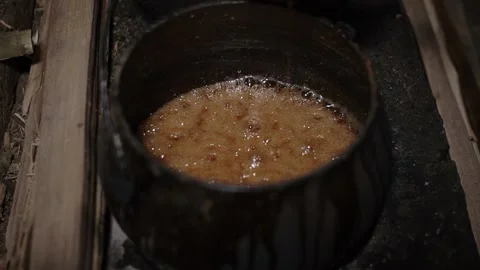 The process of boiling sap juice in a traditional kitchen takes hours Stock Footage 240071247